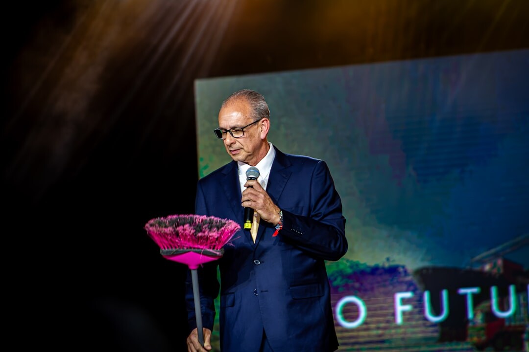 Speaker presenting on stage at a business conference